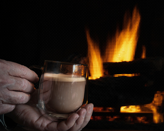 Enjoying Hot Chocolate by the Fireplace